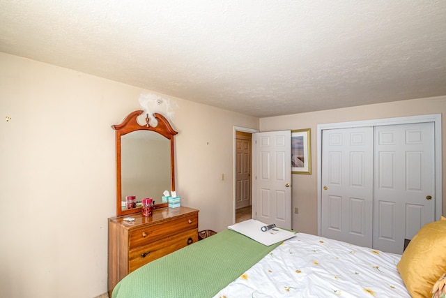 bedroom with a textured ceiling and a closet