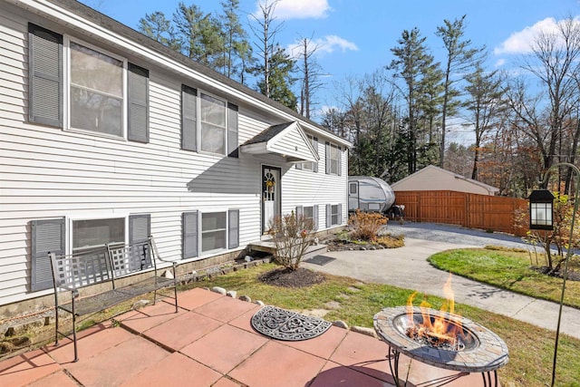 exterior space featuring a patio and an outdoor fire pit