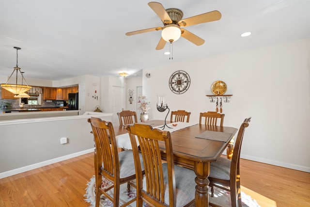 dining area with ceiling fan and light hardwood / wood-style floors