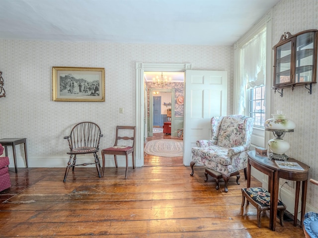 living area featuring a chandelier and wood-type flooring