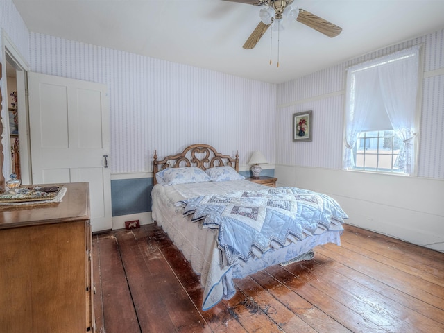 bedroom featuring ceiling fan and dark hardwood / wood-style floors