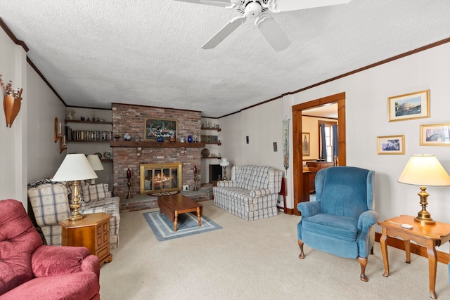 living room featuring a brick fireplace, a textured ceiling, carpet, crown molding, and ceiling fan