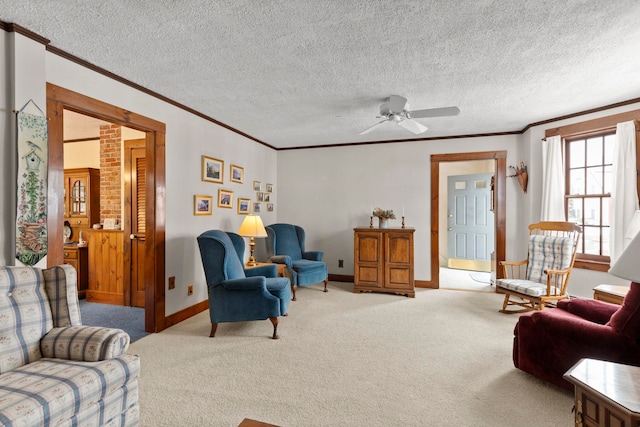 carpeted living room with ceiling fan, ornamental molding, and a textured ceiling