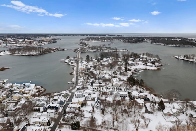 snowy aerial view with a water view