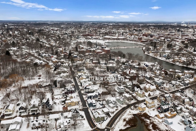 snowy aerial view with a water view