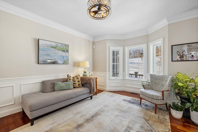 sitting room featuring hardwood / wood-style floors and crown molding