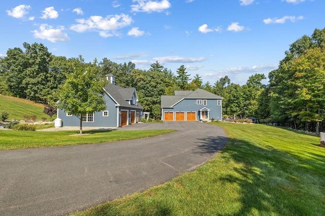 view of front of home with a garage and a front yard