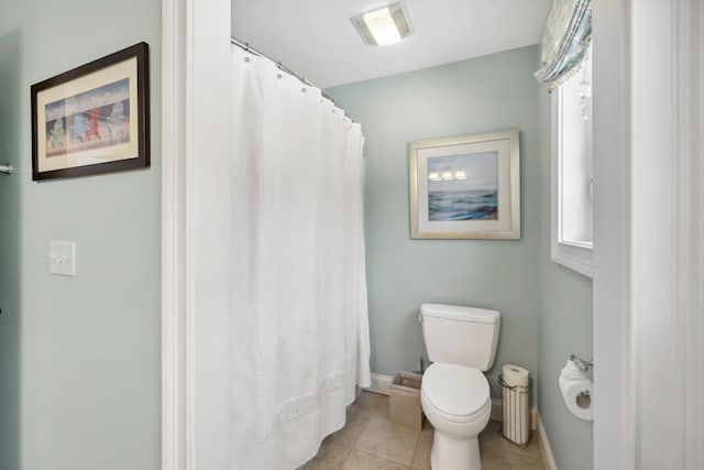 bathroom with toilet and tile patterned flooring