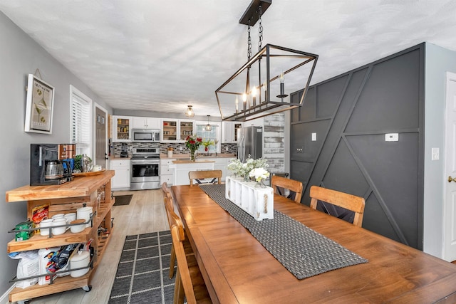 dining space with light hardwood / wood-style floors