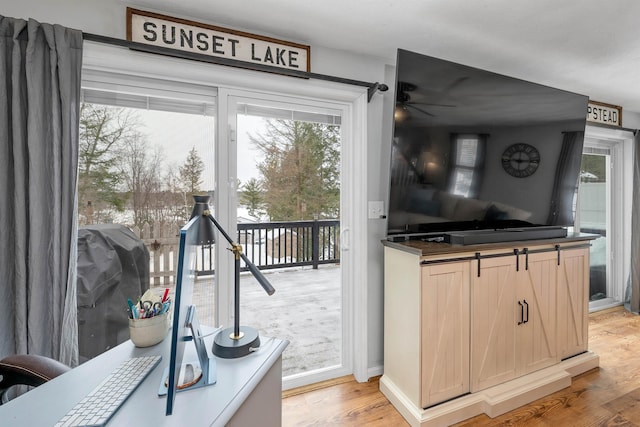 kitchen featuring light brown cabinetry, ceiling fan, and light hardwood / wood-style flooring