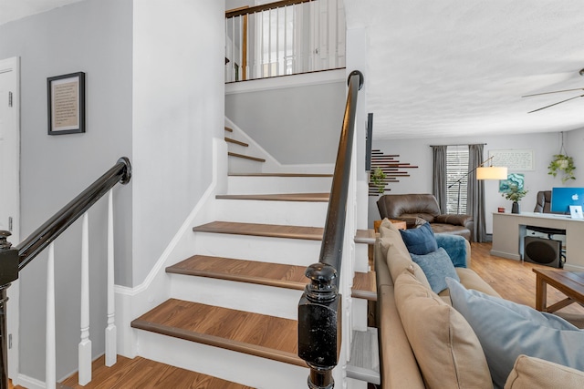 staircase with hardwood / wood-style floors