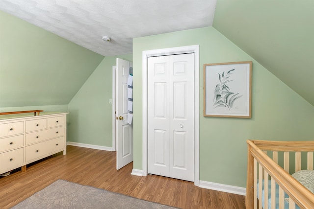 bonus room with lofted ceiling and wood-type flooring