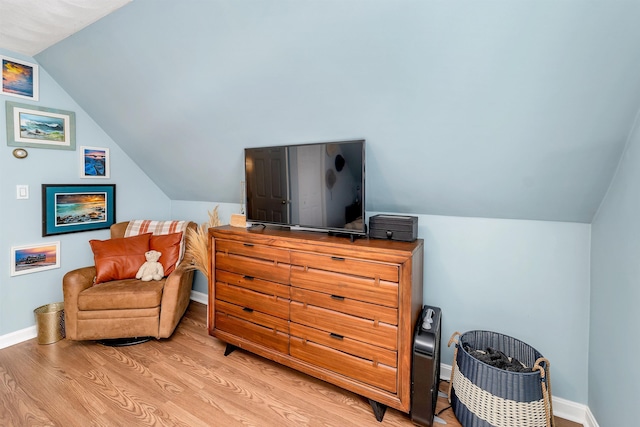 sitting room featuring light wood-type flooring and lofted ceiling