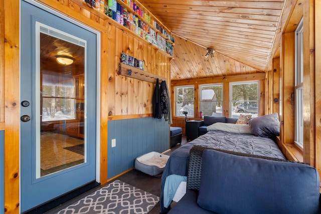 bedroom featuring wooden ceiling, vaulted ceiling, wooden walls, and dark wood-style flooring