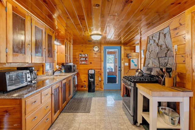 kitchen featuring brown cabinetry, wood ceiling, stone counters, and stainless steel appliances