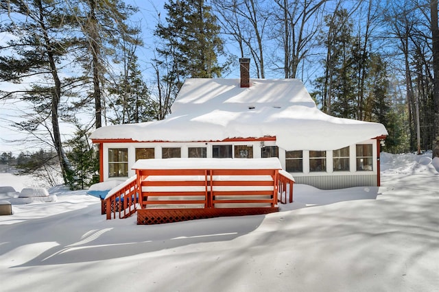 view of front of house featuring a sunroom and a chimney