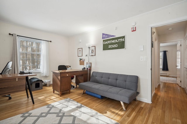 home office featuring baseboard heating, wood-type flooring, and ornamental molding