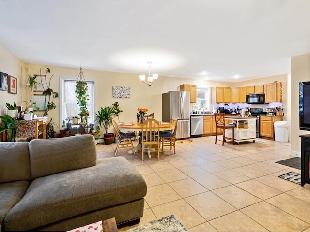 living room with light tile patterned floors and a notable chandelier