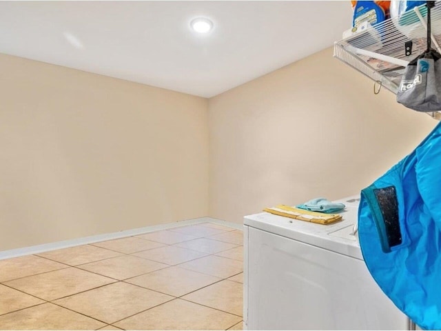 laundry room with separate washer and dryer and light tile patterned floors