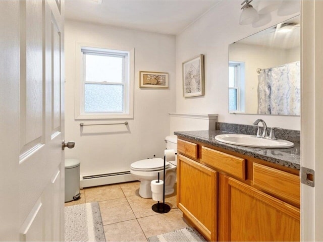 bathroom with a baseboard radiator, toilet, vanity, and tile patterned floors