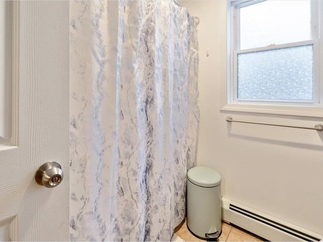 bathroom featuring a baseboard radiator and walk in shower