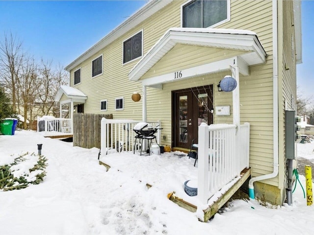 view of snow covered rear of property