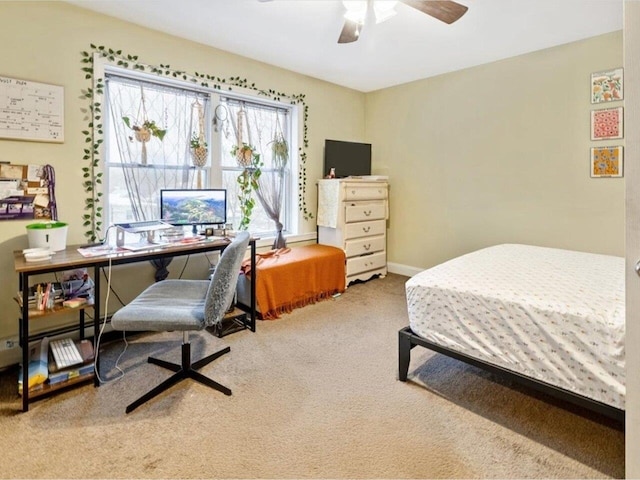 carpeted bedroom featuring ceiling fan and a baseboard radiator