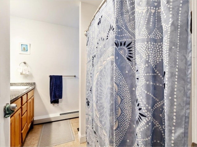 bathroom featuring vanity, a baseboard heating unit, and tile patterned floors