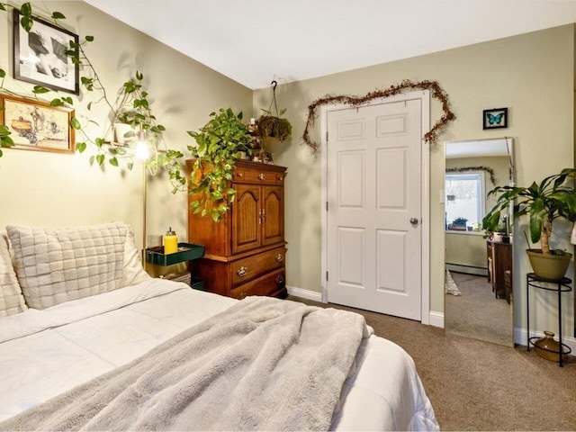 bedroom with a baseboard radiator and carpet floors