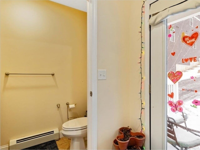 bathroom featuring tile patterned floors, toilet, and baseboard heating