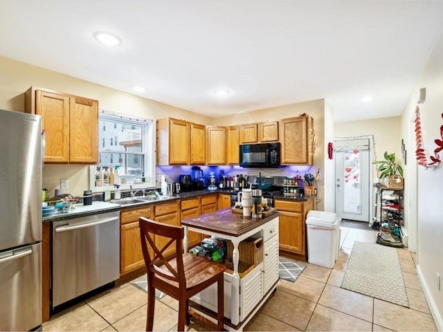 kitchen with sink, stainless steel appliances, and light tile patterned floors