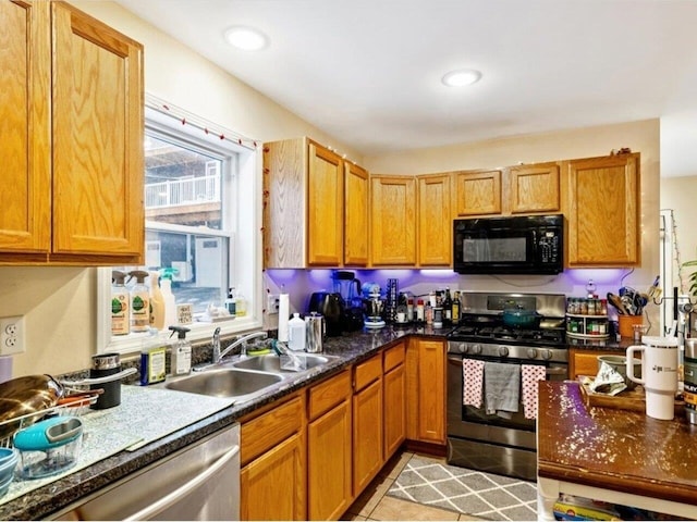 kitchen with light tile patterned floors, sink, and stainless steel appliances