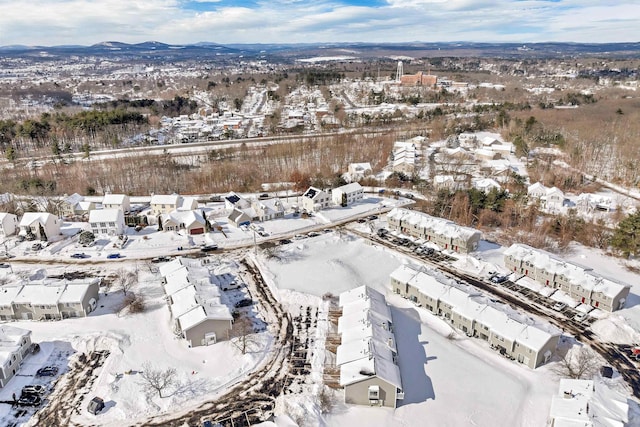 snowy aerial view featuring a mountain view