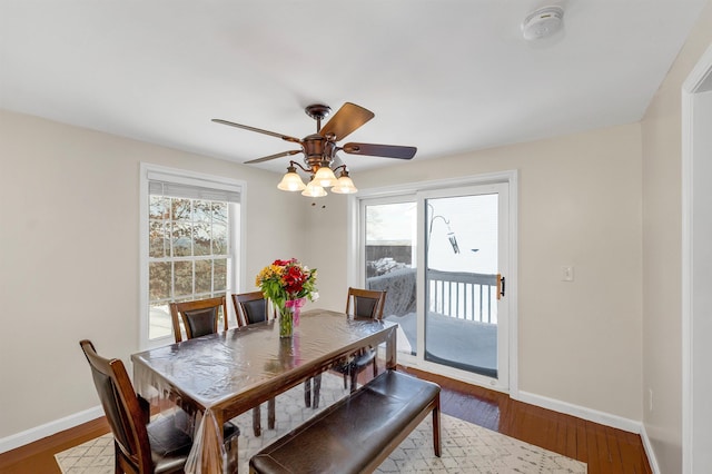 dining area with ceiling fan and dark hardwood / wood-style flooring