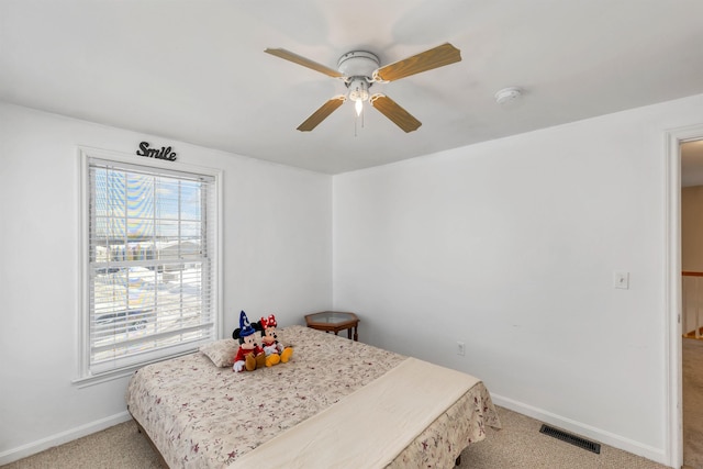 interior space featuring ceiling fan and light colored carpet