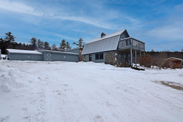 view of snow covered exterior with a wooden deck