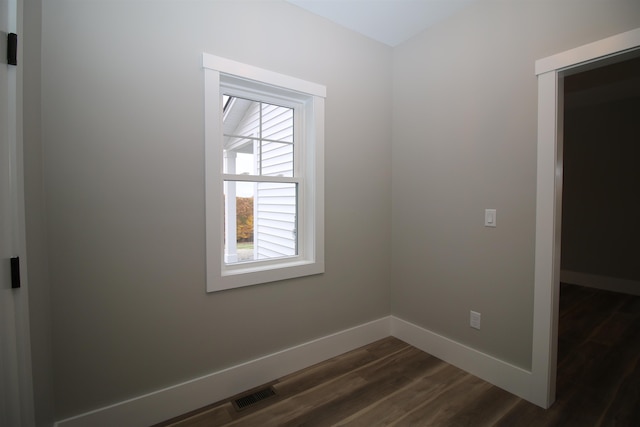 spare room featuring dark hardwood / wood-style flooring