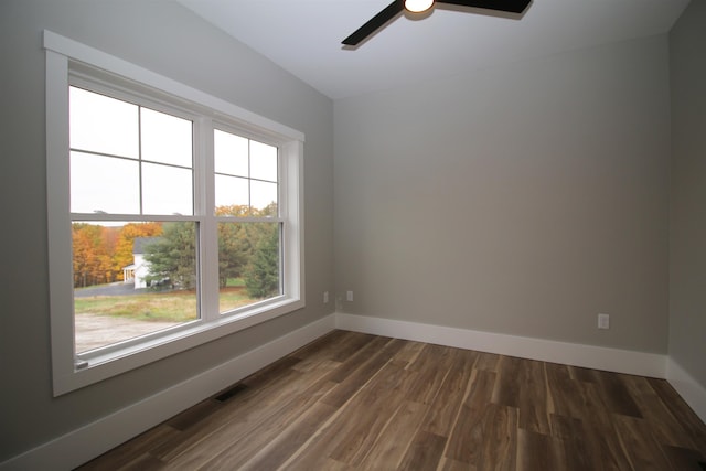 spare room with ceiling fan and dark hardwood / wood-style floors