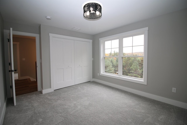 unfurnished bedroom with carpet and a closet