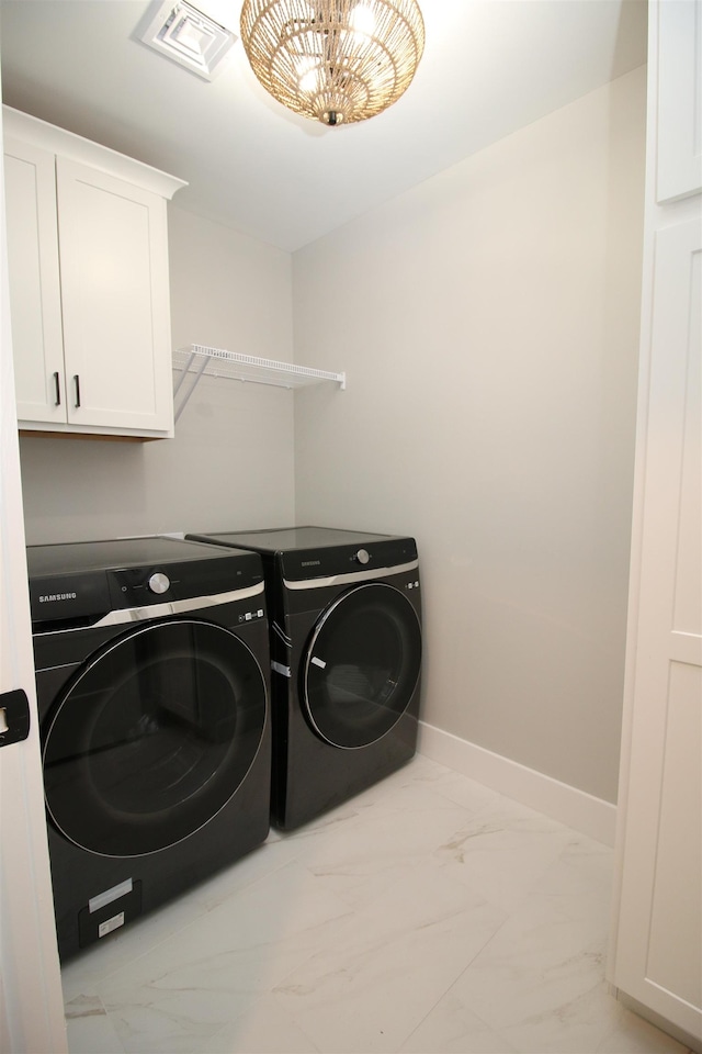 washroom featuring independent washer and dryer and cabinets