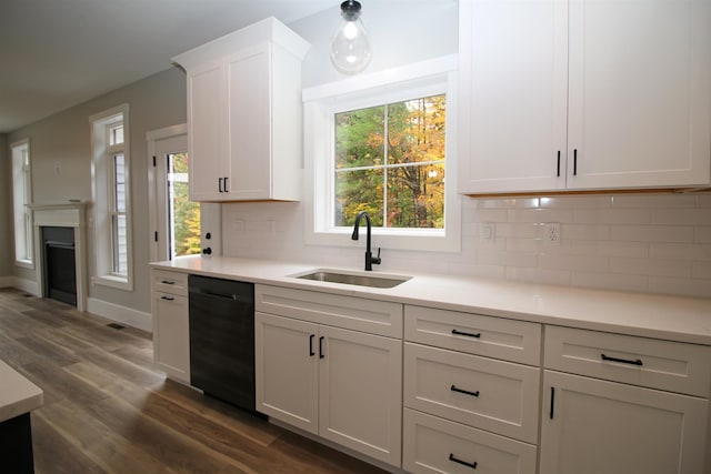 kitchen with sink, white cabinetry, dishwasher, dark wood-type flooring, and decorative backsplash