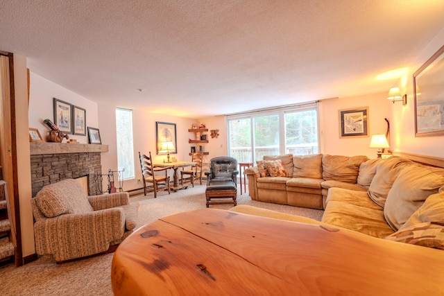 living room with carpet floors, a textured ceiling, and a stone fireplace