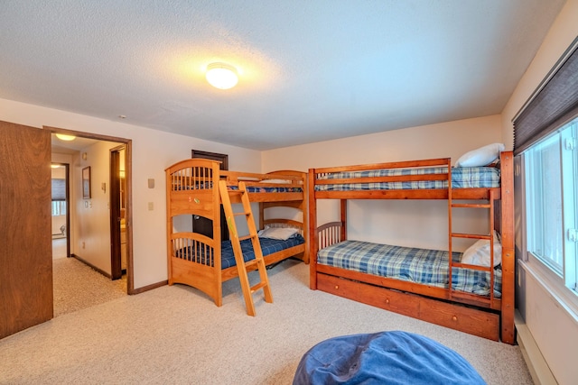 bedroom featuring light carpet and a textured ceiling