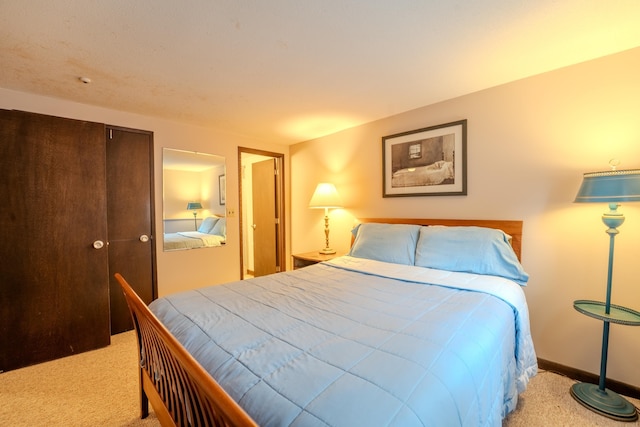 bedroom with light carpet and a closet