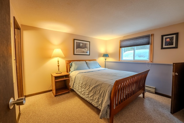 bedroom featuring carpet and a baseboard heating unit