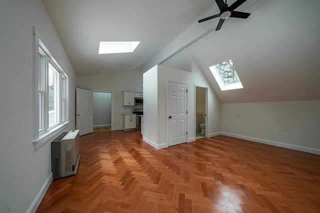 bonus room featuring light parquet flooring and vaulted ceiling with skylight