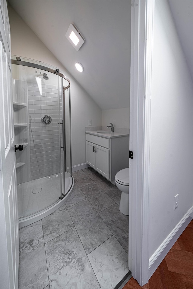 bathroom featuring vanity, vaulted ceiling, toilet, and walk in shower