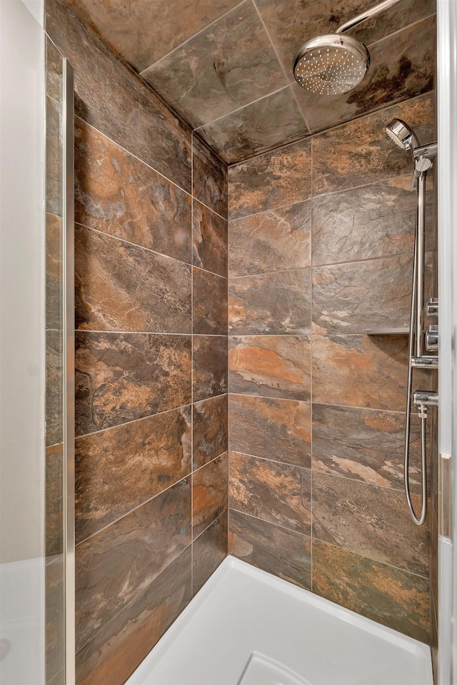 bathroom with a tile shower