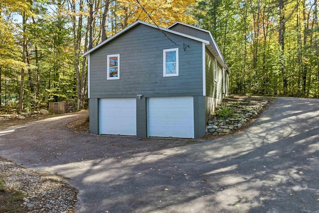 view of side of home featuring a garage