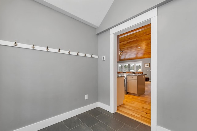 interior space with lofted ceiling and dark tile patterned floors